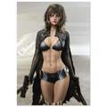 A fashion runway-style photo of a woman modeling a futuristic black outfit with a metallic black bra top, sheer black long sleeves, a black faux-leather vest, a black patterned mini skirt, and black thigh-high stockings, while holding two black pistols. The background is a clean, light gray runway setting.