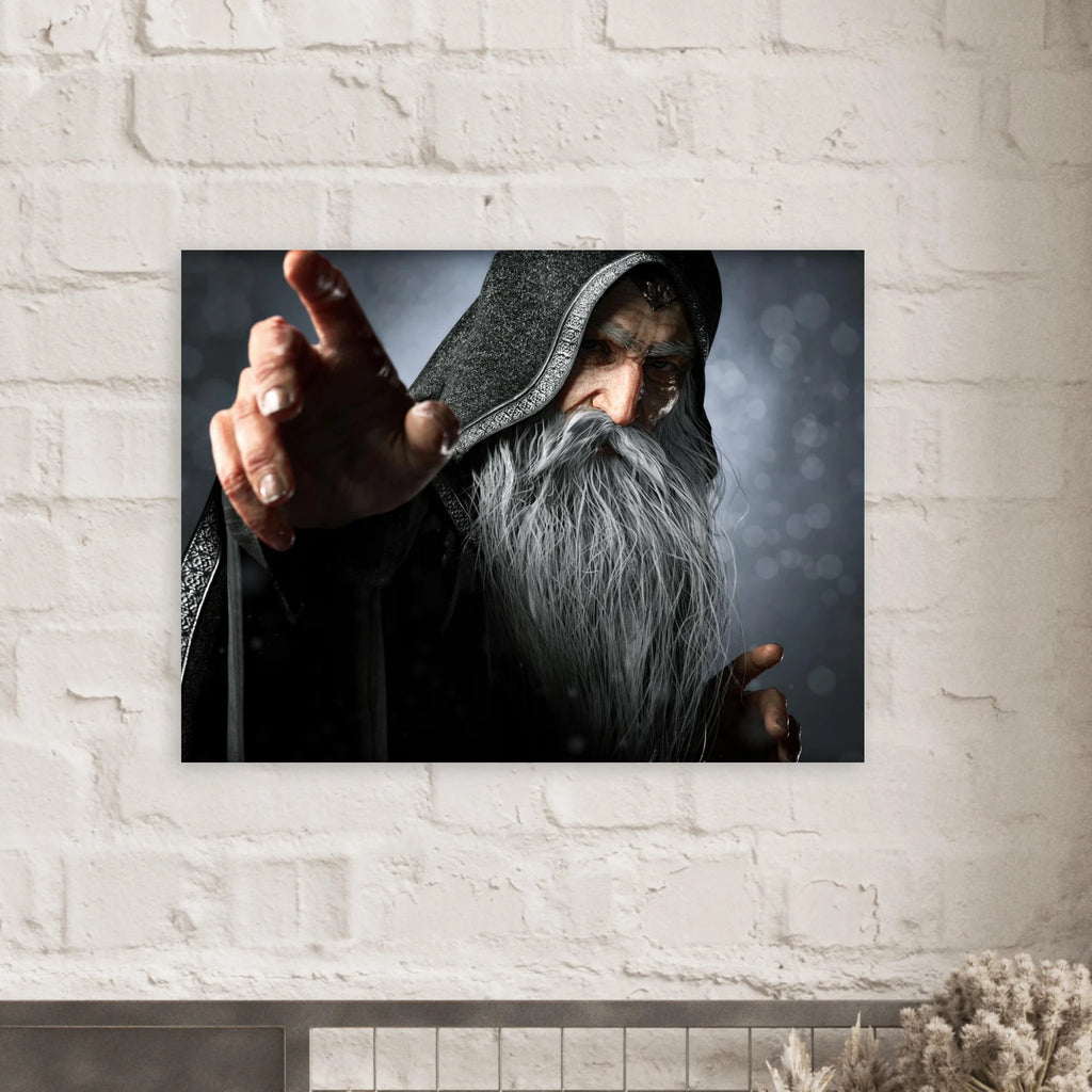 A rectangular wall art print showing a close-up portrait of an elderly wizard or sorcerer with a long gray beard, dark hood, and outstretched hand, mounted on a white painted brick wall above a mantel.