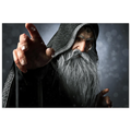 A rectangular wall art print featuring a dramatic close-up portrait of an elderly wizard or sorcerer with a long white beard, dark hooded robe, and one hand extended forward, shown against a dark smoky background.