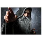 A rectangular wall art print featuring a dramatic close-up portrait of an elderly wizard or sorcerer with a long white beard, dark hooded robe, and one hand extended forward, shown against a dark smoky background.