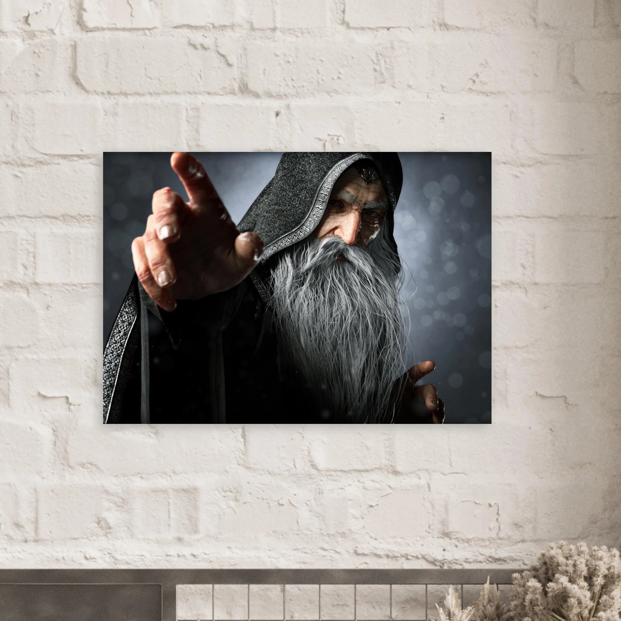 A rectangular wall art print showing a hooded wizard with a long gray beard pointing forward, mounted on a white brick wall above a mantel.