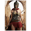 A woman wearing a Spartan warrior costume with a bronze helmet, metallic breastplate, red cape, and pleated red skirt, holding swords in a stone archway setting.