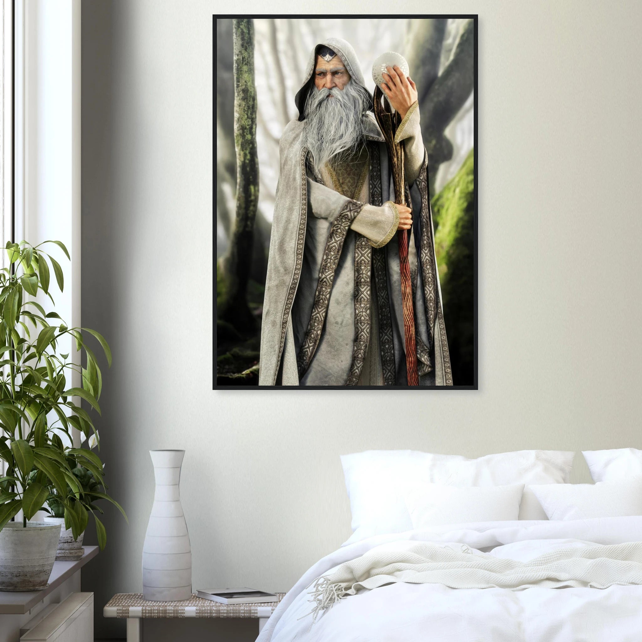A framed vertical art print of a fantasy wizard with a long white beard and staff, displayed on a light gray bedroom wall above a bed with white bedding and next to a potted plant.