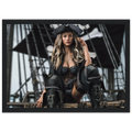 A framed art print featuring a pirate woman in a black costume with a tricorn hat and tall lace-up boots, posed in front of a ship's rigging. The print is displayed within a black frame against a white background.