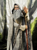 White wizard fantasy portrait with long white beard, ornate robes, mystical staff and glowing orb in an enchanted forest